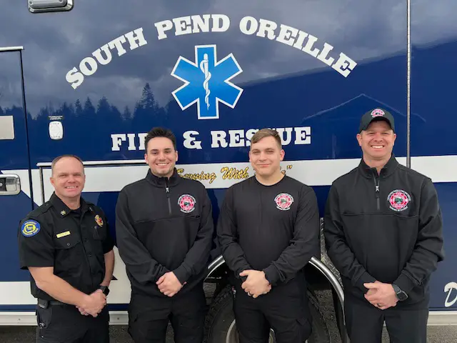 SPOFR Chief Dan Williams, left, Jake, Titus and Don are pictured in front of a new SPOFR ambulance